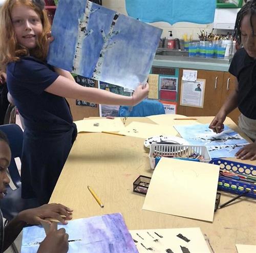 proud student with artwork 