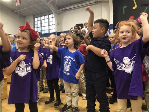 Students performing in side by side 